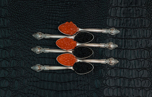 Sturgeon caviar and Alaskan salmon caviar on spoons.