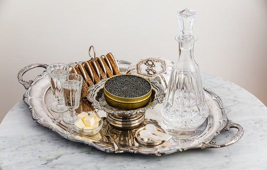Sturgeon Caviar served on ice with bread, butter, and vodka.