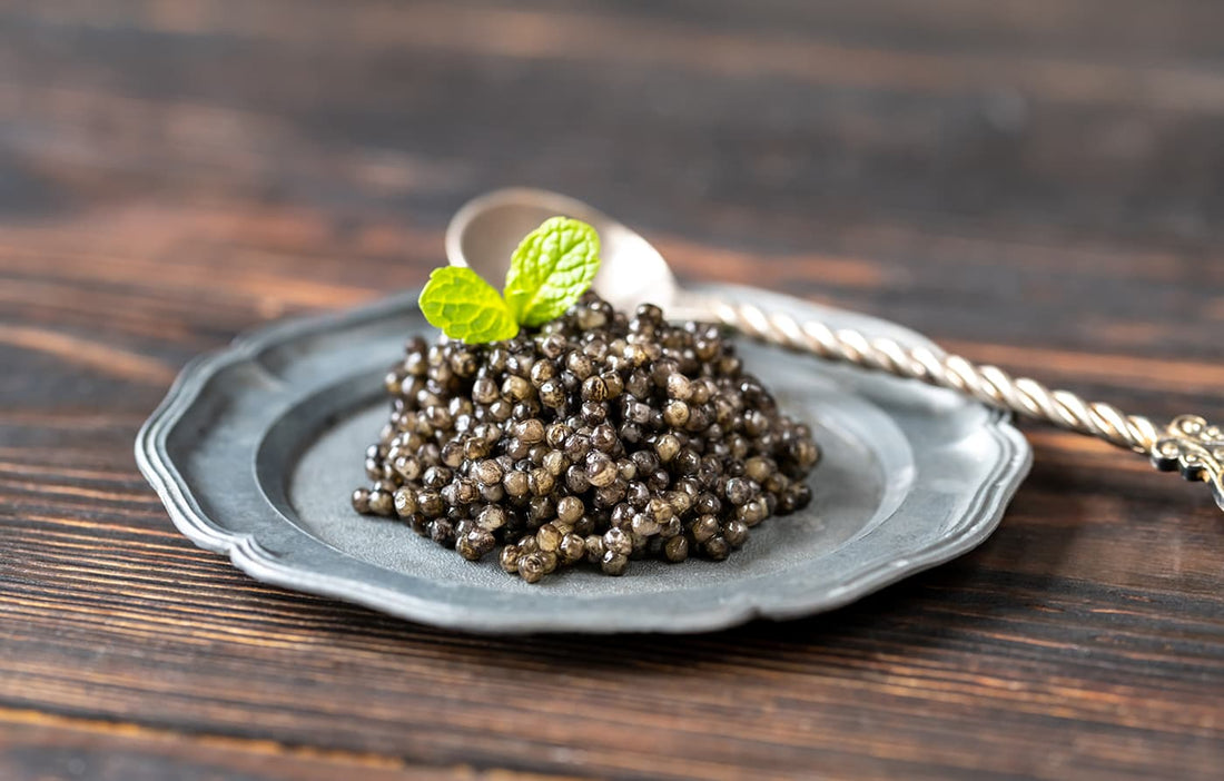 Sturgeon caviar on plate with a spoon.